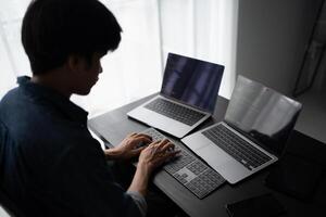 Asian man software engineer Working on Computer for writing program code Software Engineer finding errors tech photo