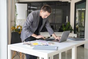 asian Business Man Artist Creative Designer sketch graphic drawing on graphic laptop and Color swatch samples Concept of idea creativity photo