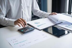 Professional Reviewing Business Data and Using Calculator photo