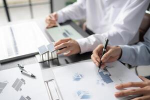 two people working on a project with blueprints. photo