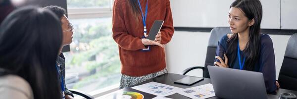 Asian business woman Application Designers presenting trending products report application planning process development software design project ux Graphic designer. photo