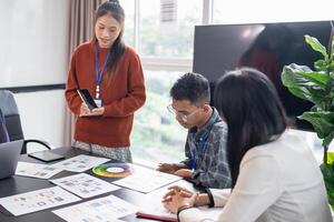 Asian business woman Application Designers presenting trending products report mobile application planning process development software design project ux Graphic designer. photo