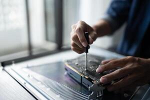 a person is working on a computer with a screwdriver. photo