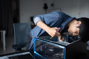 a man is working on a computer in a room. photo