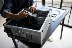 a man is working on a computer case photo