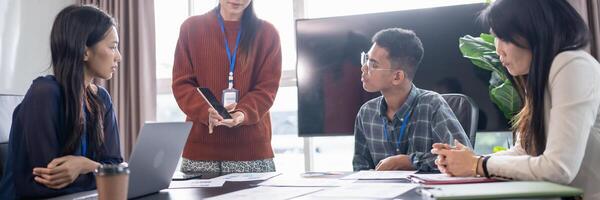 Asian business woman Application Designers presenting trending products report mobile application planning process development software design project ux. photo