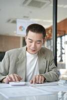 Confident asian business man Auditor or internal revenue service staff checking annual financial statements company Audit Accounting tax photo