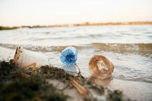 Trash on, the shore, conception of the ecology and Earth day photo