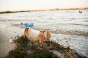 Trash on the ,shore, conception of the ecology and Earth day photo