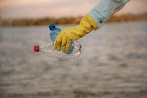 Trash ,pollution. Close up view of female ,volunteer that is holding plastic bottle. photo