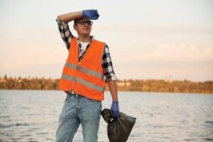 Man, volunteer is against Earth pollution by trash, outdoors photo