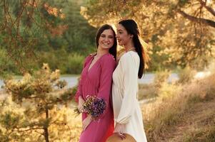 Young ,and happy, having,,, Lovely lesbian couple are together outdoors in nature photo