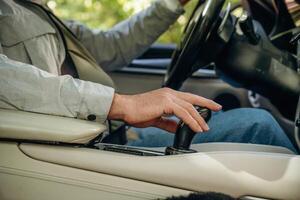 Side view ,,of ,senior man that is driving a car photo