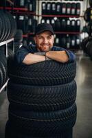 Inside of the wheels, having fun. Man ,,,,worker is maintenance station with tires photo