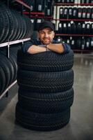 Inside ,of, the ,,wheels, having fun. Man worker is maintenance station with tires photo