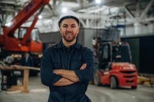 Front ,view, standing.. Male worker is in the modern warehouse or manufacturing company photo