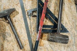 Construction tools on the wooden table, close up view photo