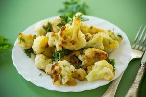 Rustic vegetable dish with cabbage and herbs on a green background photo