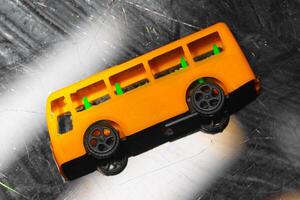 plastic model of a yellow school bus, showcasing a nostalgic representation of childhood and transportation. yellow school bus plastic toy model photo