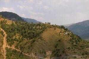 Scenic landscape panoramic view of the forested Himalaya mountains photo