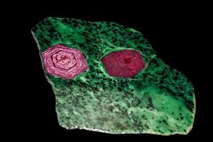 Macro of mineral, stone ruby in rock on black background photo