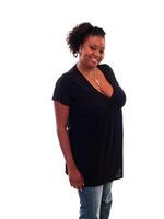 Smiling Plump African American Woman Standing In Black Top And Jeans photo