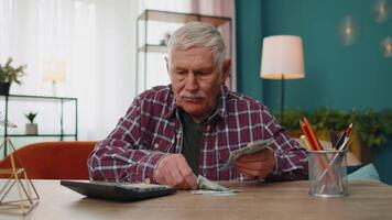 Happy grandfather man counting calculating cash money dollars planning expenses financial budget video
