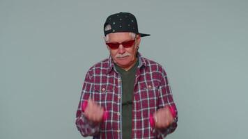 Elderly senior man making fitness exercises with dumbbells alone, working out pumping up arm muscles video