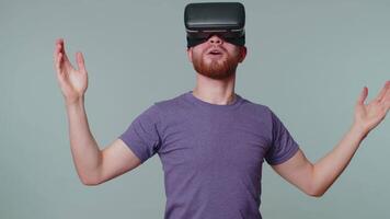 Man using virtual reality futuristic technology VR headset helmet to play simulation 3D game video