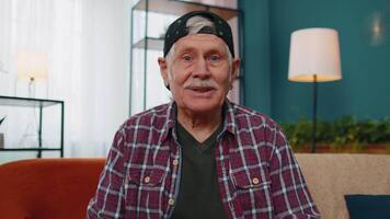 POV of senior grandfather making online webcam call talking waving hand looking at camera video