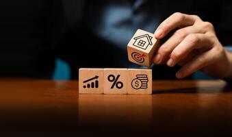 Real estate investment, financial planning, and business growth strategy concept with hand stacking wooden blocks. Property investment, mortgage rate, profit planning, and wealth management. photo