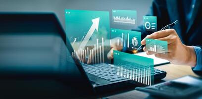 Modern financial analysis and business intelligence concept with digital dashboard interface, data visualization, and futuristic charts. Businessman using laptop and pen for strategic planning. photo