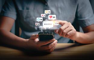 Social media interaction and online engagement concept with smartphone notifications. User touching screen to respond to likes, messages, and comments. Digital communication and network connection. photo