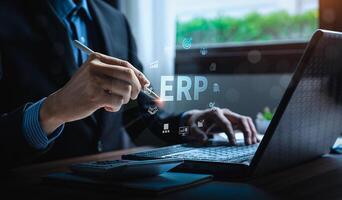 Business professional using ERP system for financial management and business operations, with digital icons representing enterprise resource planning, automation, and data integration photo