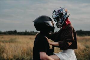Couple of lovers kissing and hugging on motorbike photo
