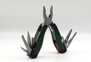 Multi tool with multiple functions and pliers isolated on white. photo