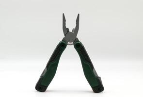 Multi tool with multiple functions and pliers on white background. photo