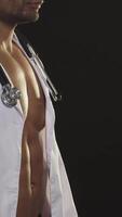 Confident athletic African man in lab coat and stethoscope exuding charm video