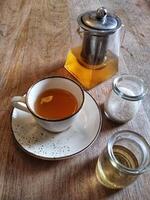 A cup of tea and a small jar of salt photo
