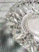 A glass ashtray on a table photo