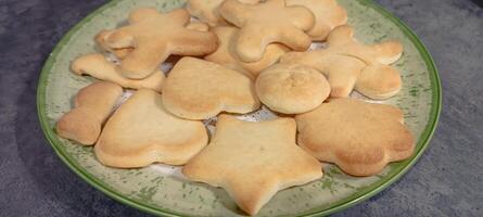 figured homemade cookies of different shapes on a flat plate. photo