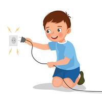Little boy play with electricity put a plug into socket vector