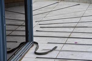 A reflection of a door is seen in a window. The reflection is of a person standing in front of the door photo