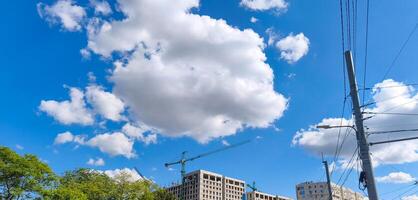 A blue sky with a large cloud in the middle. The sky is clear and bright, with the cloud adding a sense of depth and interest to the scene photo