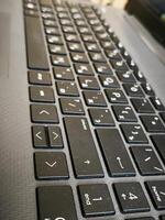 A black keyboard with a few keys missing. The keys that are missing are the enter key and the shift key photo