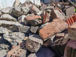 A pile of bricks and rocks with a few bricks missing. The pile is large and has a lot of space between the bricks photo