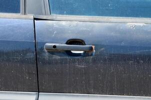The car door is open and the handle is missing photo