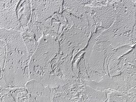 A wall with a textured surface. The texture is rough and uneven, giving the wall a rugged appearance photo