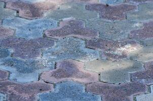 A mosaic tile pattern with a blue and gray color scheme. The tiles are arranged in a way that creates a sense of depth and texture photo