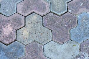 A mosaic tile pattern with a blue and pink tile. The tiles are arranged in a way that creates a sense of depth and texture photo